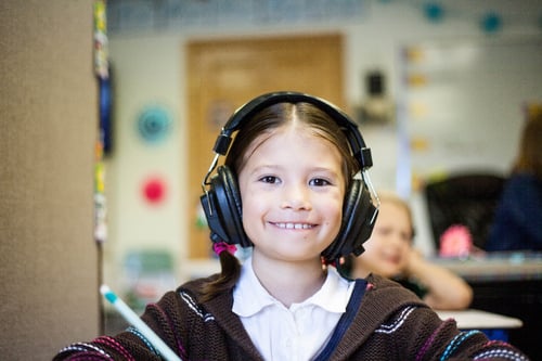 Banner of child smiling with headphones on