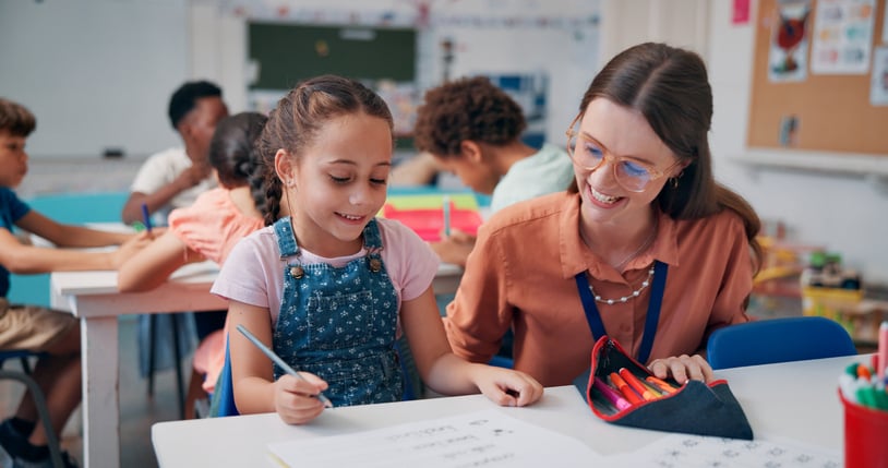 Teacher with Student in Classroom